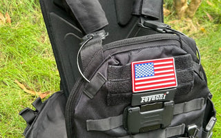 Feyachi TM-20 Magnetic Tactical Vest displayed on grass with shoulder straps visible.