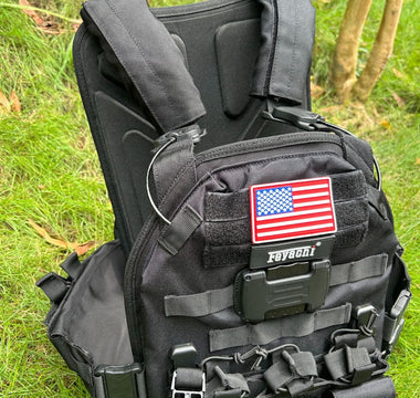 Feyachi TM-20 Magnetic Tactical Vest displayed on grass with shoulder straps visible.